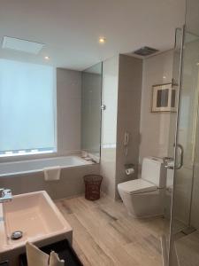 a bathroom with a sink and a toilet and a shower at The Jade Boutique Hotel in Wuhan +27 photos