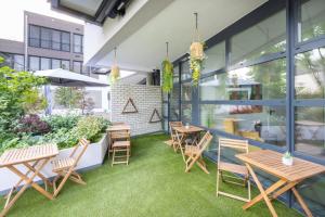 an outdoor patio with wooden tables and chairs at Belnoir by BRIGHT in Augsburg +77 photos