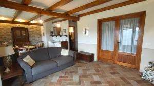 a living room with a couch and a table at Casa La Crocetta Da Marco in Castelletto Soprano
