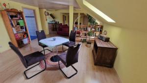 a living room with a table and chairs at Ferienwohnung Wiesental II, Wiesentalstrasse 1, 89331 Burgau in Burgau