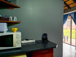 a kitchen with a microwave and a counter top at Munati B&B in Musina