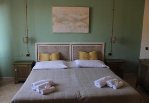 a bedroom with a bed with two towels on it at Hotel Monte Sirai in Carbonia
