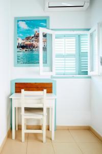 a white desk with a chair and a window at Hostal Sunset Ibiza in San Antonio +32 photos