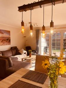 a living room with a couch and a table at Haus Friesenliebe in Greetsiel