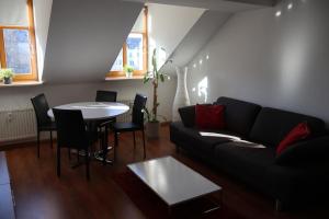a living room with a couch and a table at alexxanders Apartments & Studios in Chemnitz