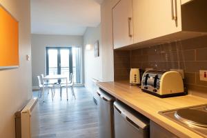 a kitchen with a counter top with a toaster on it at Radical Edward Square Apartments in Galway
