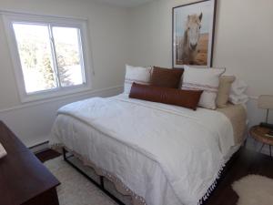 a bedroom with a bed with a horse picture on the wall at Blue River Condos 3 Bed 2 Bath BRLR in Blue River