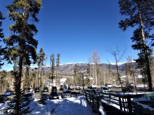 a parking lot with cars parked in the snow at Treehouse 2 bed 2 bath C THWC in Silverthorne