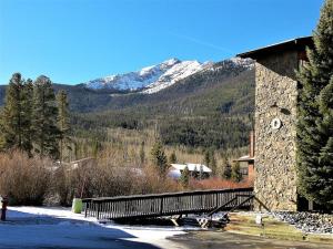 a bridge with a snow covered mountain in the background at Mountainside 2 Bed 2 Bath MSBD in Frisco