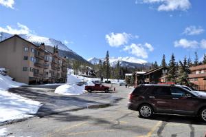 a suv parked in a parking lot in a mountain town at Buffalo Ridge 2 Bedrooms 1 Loft BRBF in Silverthorne