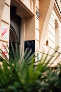 a sign on the side of a building at Hôtel Azur in Reims
