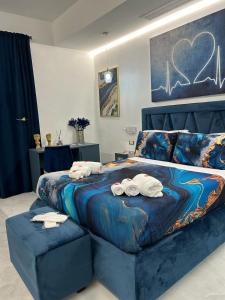 a bedroom with a large bed with towels on it at Nuance Suite & Rooms in Lecce
