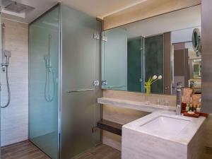 a bathroom with a sink and a shower at Rixos Premium Tekirova - The Land of Legends Access in Tekirova