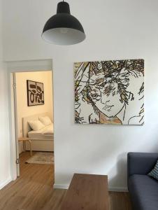 a living room with a painting on the wall at Maze Apartments - Perfectly located brand new flats in Tel Aviv