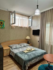 a bedroom with a bed and a table at Kesane in Telavi