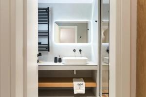 a bathroom with a sink and a mirror at LIMNI Boutique Experience Evia in Límni