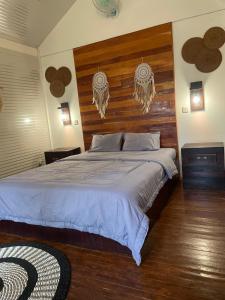 a bedroom with a large bed with a wooden headboard at Balla Naila in Gili Trawangan
