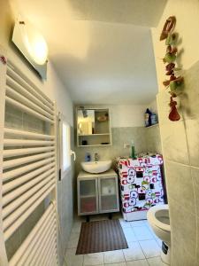 a small bathroom with a sink and a toilet at Bilocale in centro con vista mare in Porto Santo Stefano +24 photos