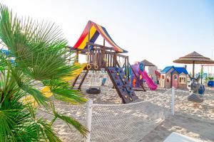 a playground with a slide on the beach at Hotel Cola Frontemare in Bellaria-Igea Marina