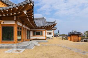 a house in an asian style with a roof at Luxury Hanok Blue Serenity in T'ongjin