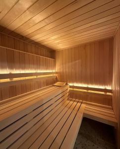an empty wooden sauna with a wooden floor and wooden floors at Hôtel et SPA du Château in Lagord