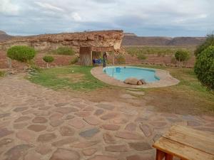 a small swimming pool in the middle of a field at Hais Ra Tented Campsite in Khorixas