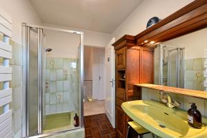 a bathroom with a sink and a glass shower at Ty Nehue - Maison avec jacuzzi in Crach +17 photos