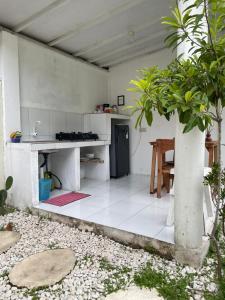 a kitchen with a counter and a table in a room at Balla Naila in Gili Trawangan