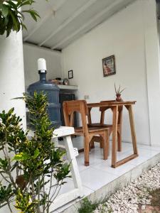a table and chair on a patio with a stove at Balla Naila in Gili Trawangan +10 photos