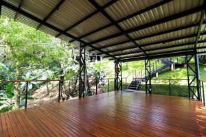 a large wooden deck with a view of a forest at Sueño Río Celeste Boutique B&B in Bijagua