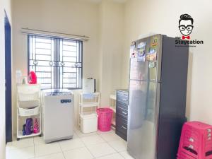 a kitchen with a refrigerator with a cartoon on it at Staycation Homestay 68 Kch City Mall in Kuching