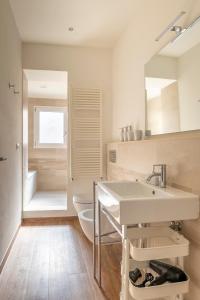 a bathroom with a sink and a toilet and a mirror at Tra Duomo e Uffizi Appartamenti moderni nel cuore dell'arte in Florence
