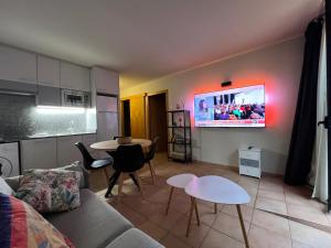 ein Wohnzimmer mit einer Couch und einem Fernseher an der Wand in der Unterkunft Placer, naturaleza y terraza en Canillo Serrera 3 HUT-8207 in Canillo