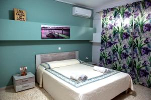 ein Schlafzimmer mit einem Bett mit Blumentapete in der Unterkunft Cosy House 50m of Beach Kalamia 80 sqm in Korinthos