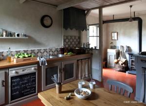 a kitchen with a counter and a table in it at Le Mas du Naoc in Cabris