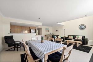 a dining room and living room with a table and chairs at 62CapeView Geographe bay in Broadwater