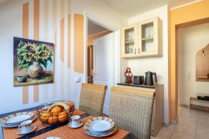 a dining room with a table with a bowl of fruit on it at City Apartman Eger in Eger +3 photos