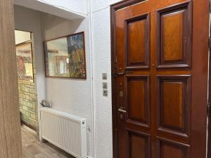 a wooden door in a room with a hallway at Lina House in Nikiti