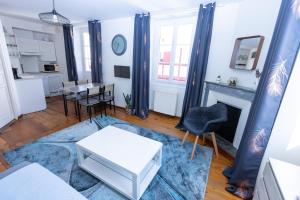 a living room with a table and a fireplace at Villa Erdian in Saint-Jean-de-Luz