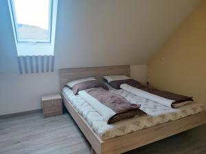 a large wooden bed in a room with a window at Ferienwohnung Mühlbach in Igensdorf