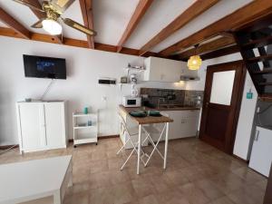 a kitchen with white cabinets and a table at Casa Linda in Parque Holandes +21 photos