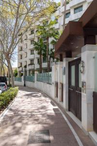 a sidewalk in front of a building with a building at Luxury apartment in Jardines del Principe in Marbella