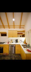 a kitchen with a stainless steel stove and a sink at Kala Cabin Classic in Bongkor 1