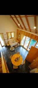 a living room with a wooden table and a couch at Kala Cabin Classic in Bongkor 1