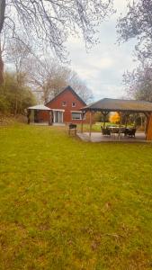 a park with a gazebo and picnic tables at Haus am Deich in Butjadingen