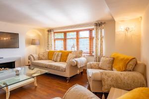 a living room with two couches and a table at Abbey Farm House - Pet Friendly in Ormskirk
