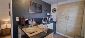 a kitchen with a counter with wine glasses on it at Le TOURNY-Studio cosy avec ascenseur- Sarlat - Coeur cité médiévale in Sarlat-la-Canéda