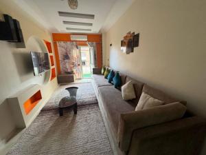 a living room with a couch and a table at Hurghada Sea View Apartment in Hurghada