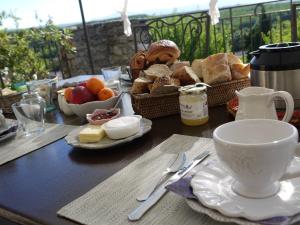 a table with a plate of bread and a cup of coffee at La Ferme les Eybrachas in Réauville