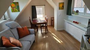 a living room with a couch and a table at FeWo Gisela in Fehmarn